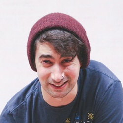 Man in a woollen cap smiling