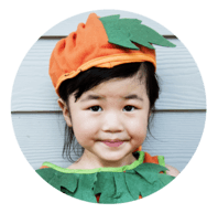 Little kid in pumpkin costume