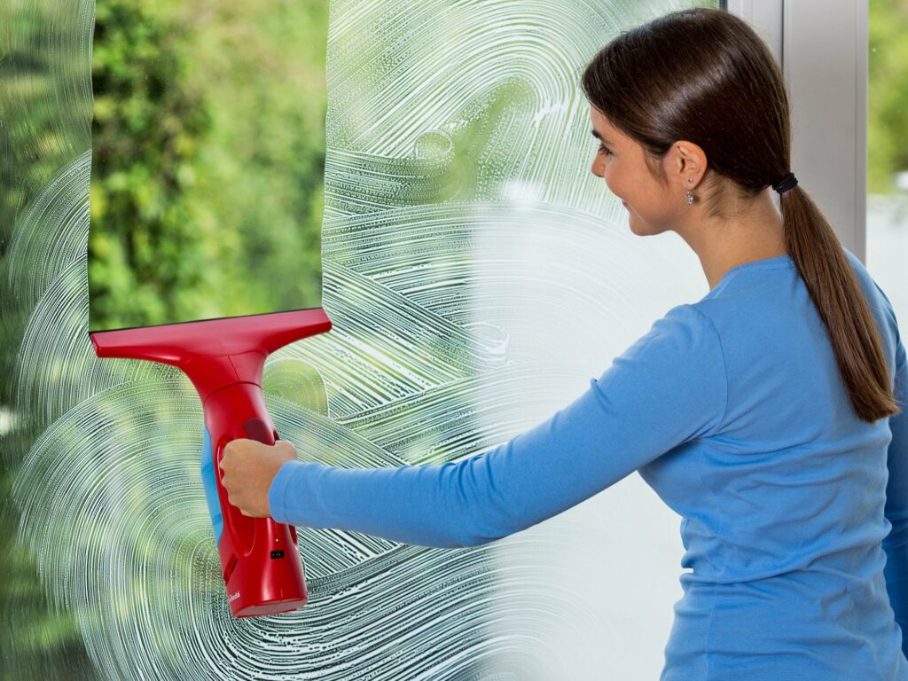 Woman cleaning window