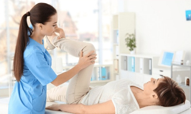Physiotherapist giving a woman treatment