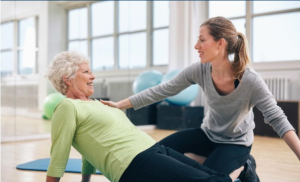 Yoga instructor helping woman