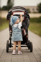 Little girl with baby carriage