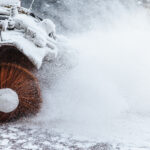 Snow plow does removal after blizzard in winter. Snow blower in motorway. Winter service on road. Weather conditions. Cleaninng snow concept