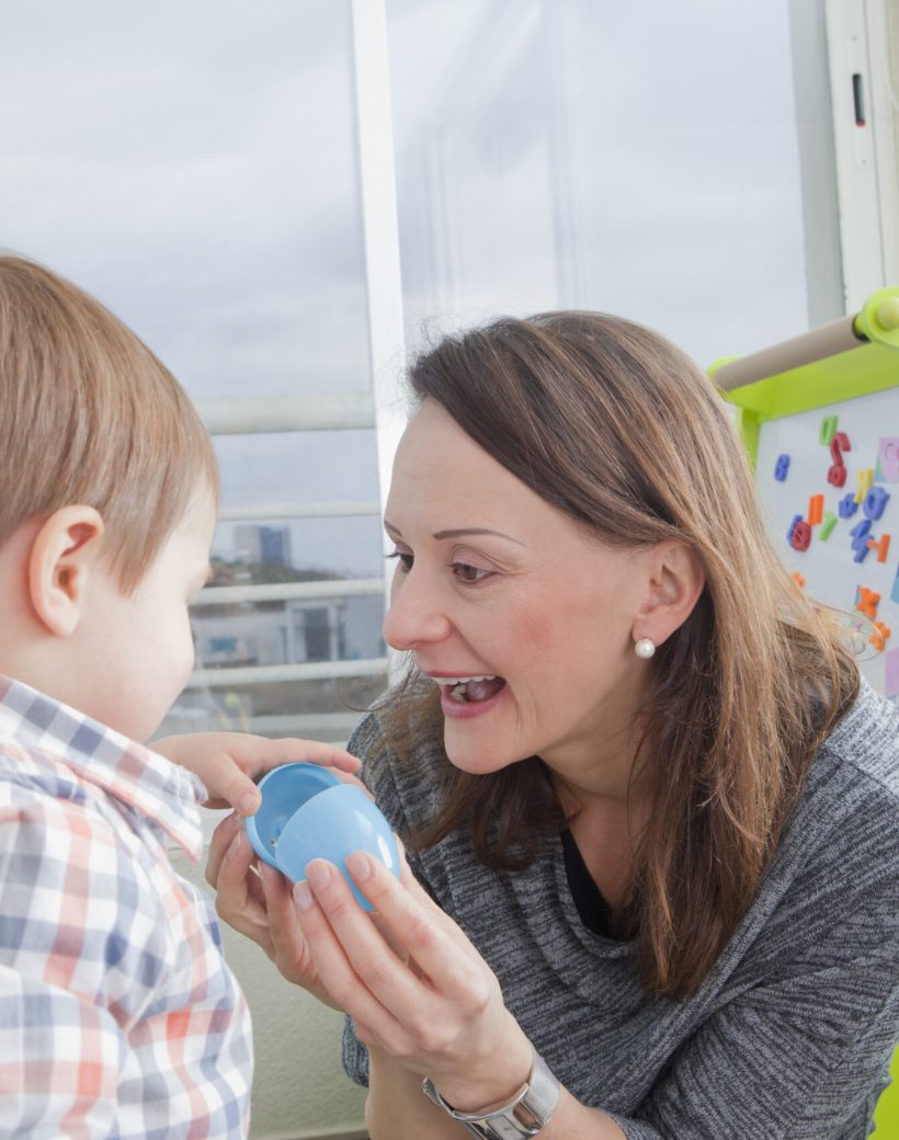Mother playing with son at home